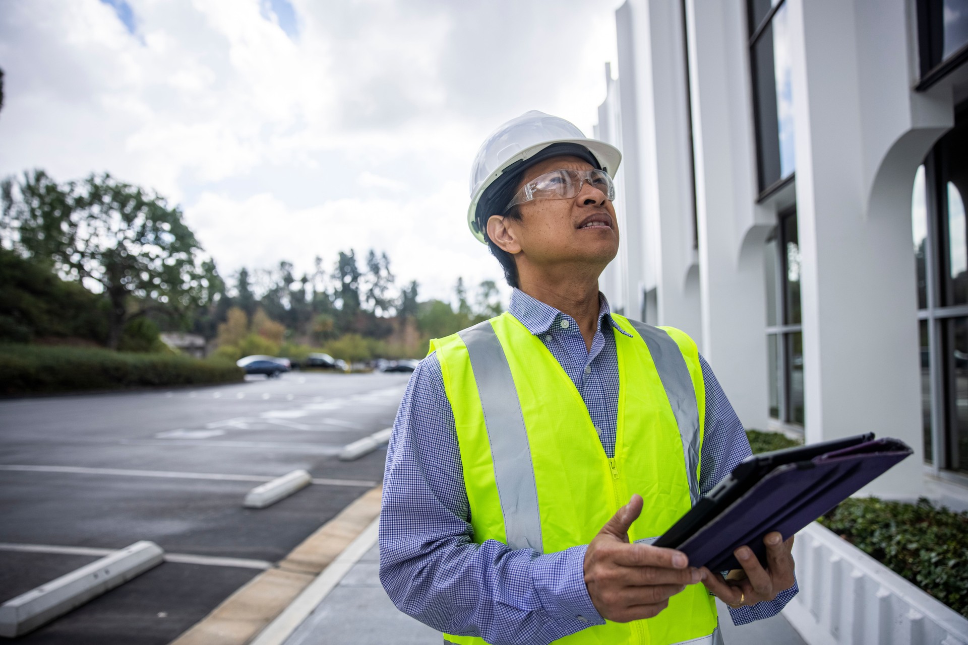 Mature Filipino Man with Tablet Inspecting a Building